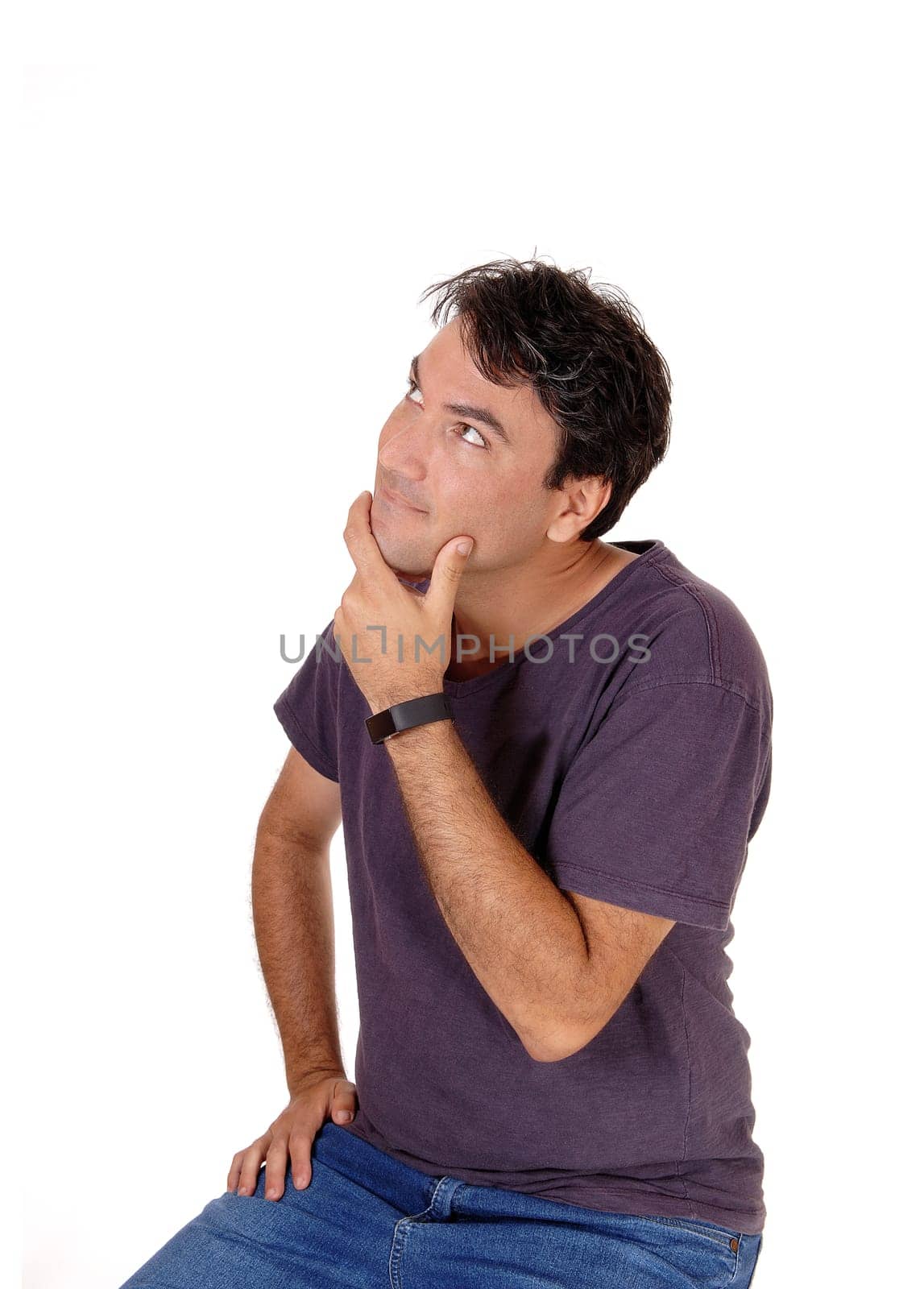 A young man wondering what is happened, holding one hand on his.chin and looking up, isolated for white background.