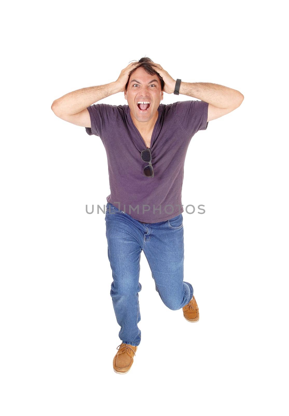 A screaming young man running of frustration about the news he .heard, isolated for white background.