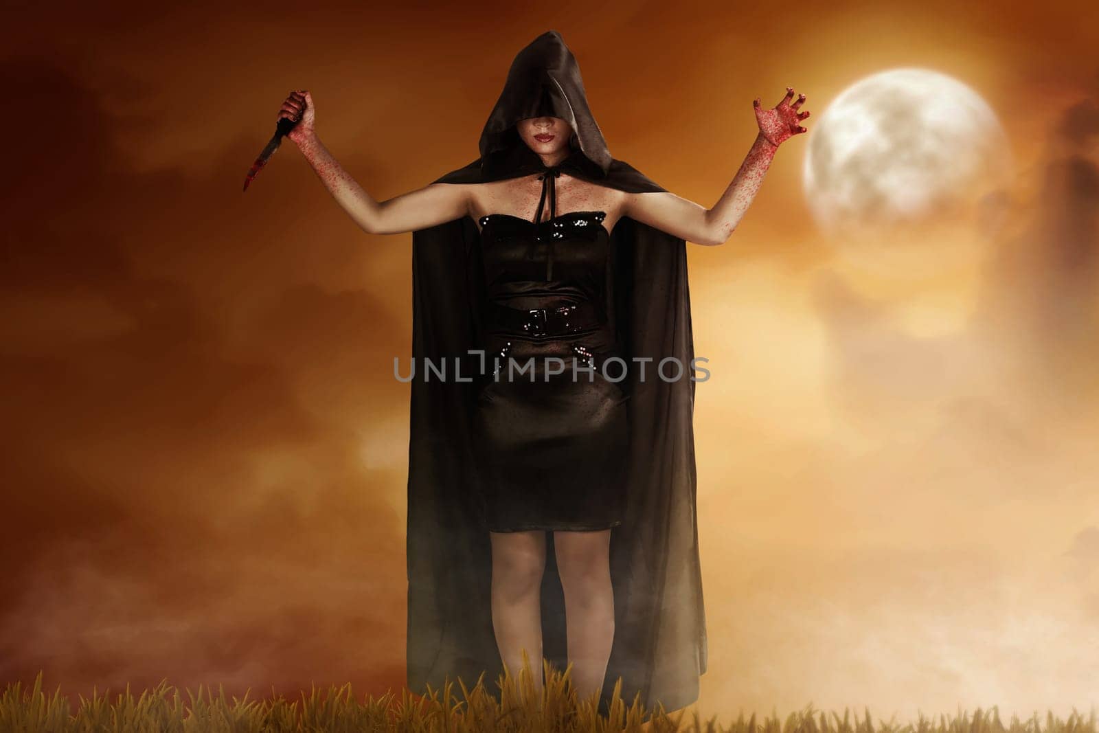 Young witch woman in black hooded cloak holding bloody knife with dramatic scene background