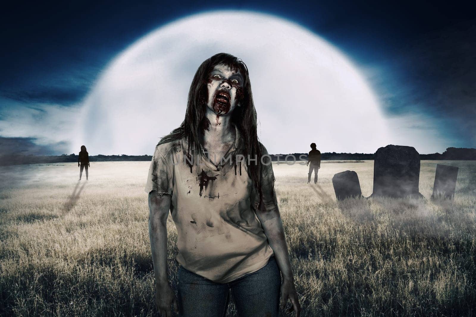 Zombies walking around on the cemetery at night