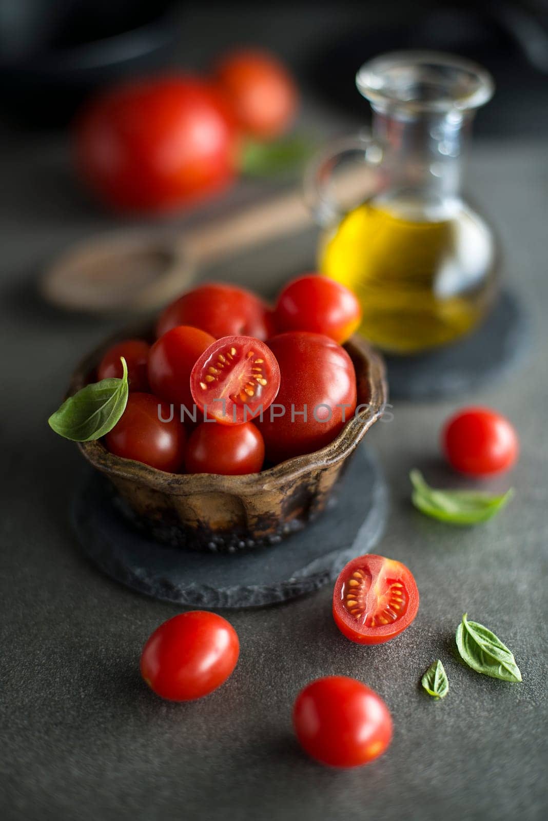 Cherry tomatoes wiith ingredients and spices. Concept for a tasty and healthy meal.