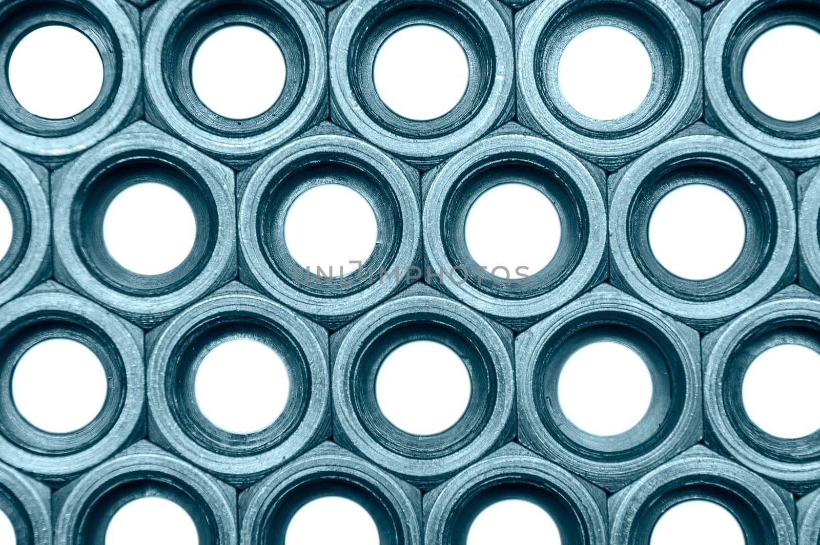 Full-framed arrangement of monochrome union nuts isolated on white.