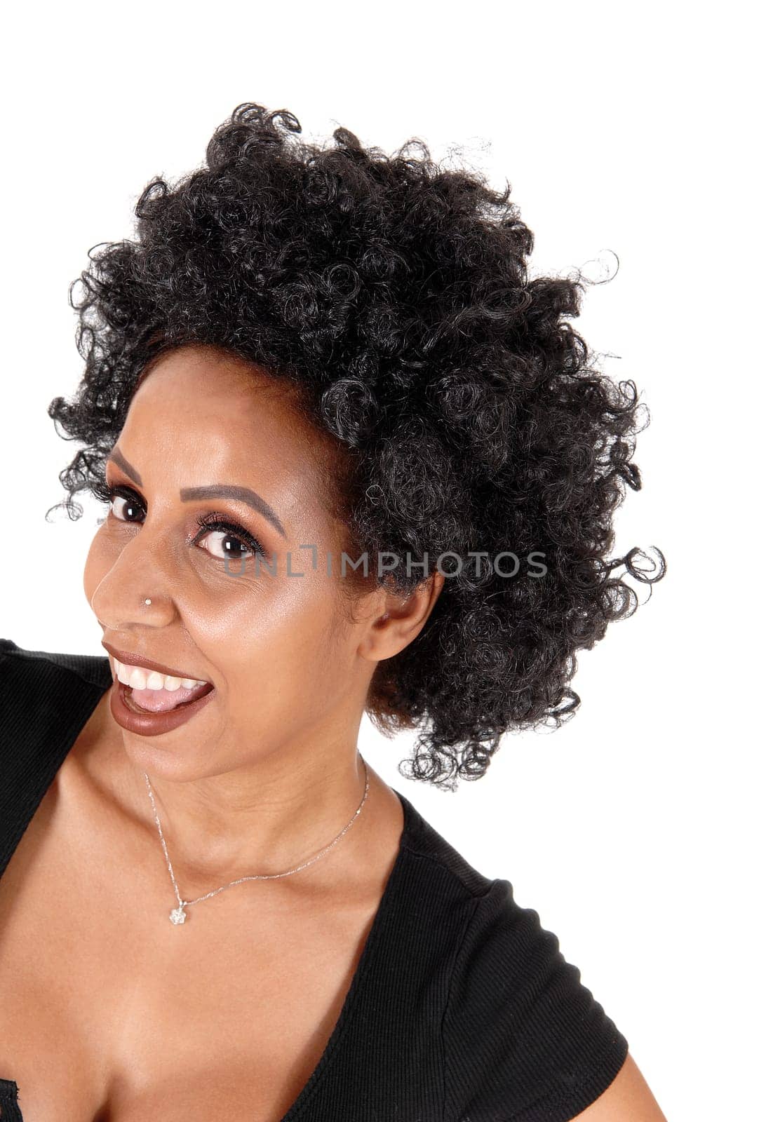 A lovely young woman in a portrait with very fussy curly black hair.laughing with her mouth open, isolated for white background.