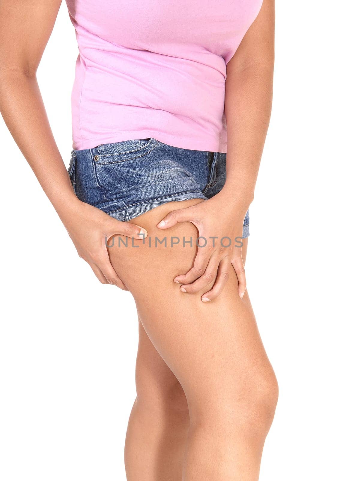 A close up image of the legs of a young woman in jeans shorts checking.her tights and there are OK, isolated for white background.