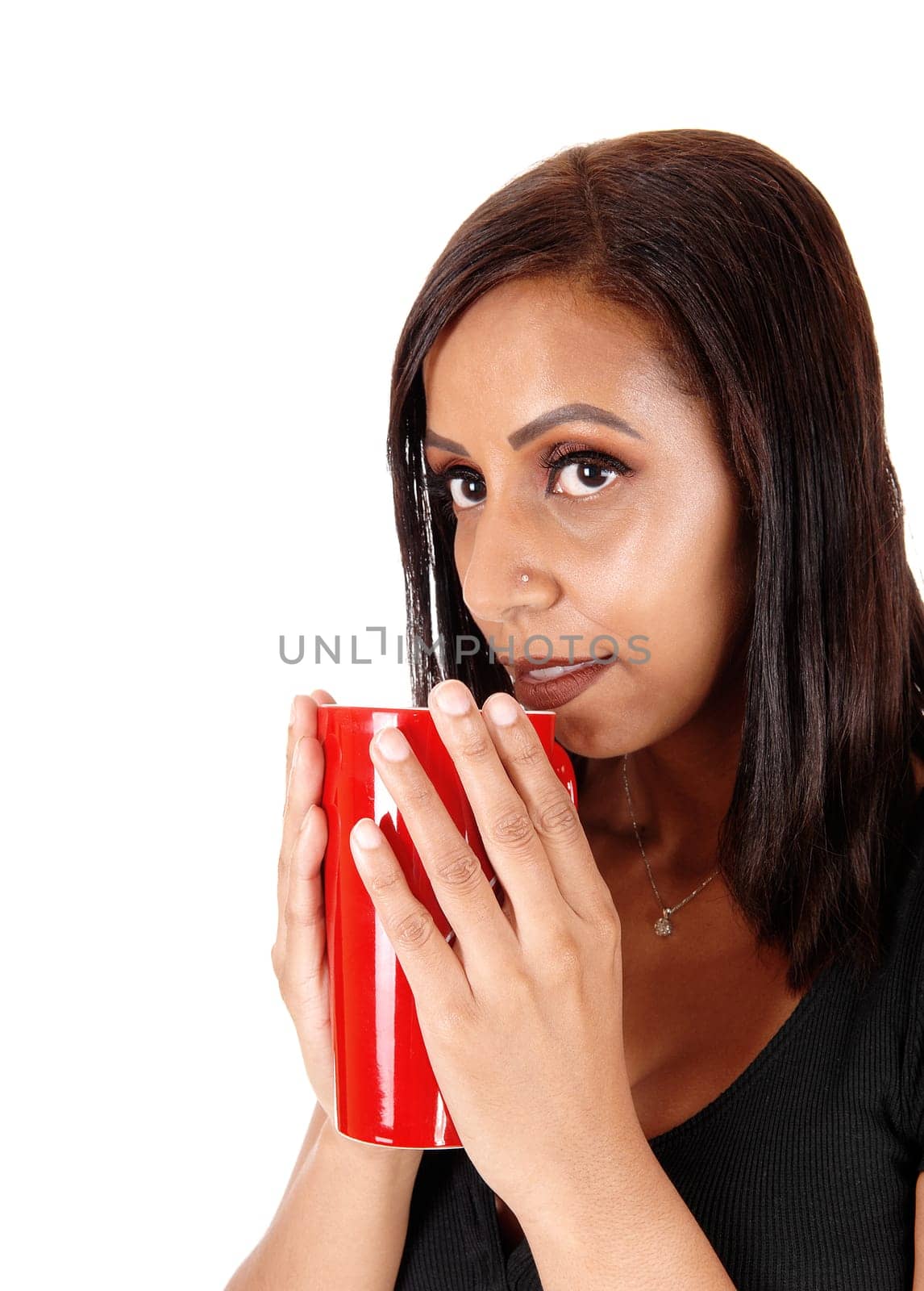 A close up image of a young woman holding a red big mug with coffee.enjoying it in the morning, isolated for white background.