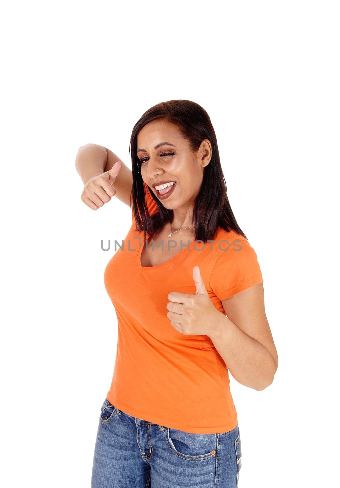 A happy smiling woman standing in jeans and a sweater showing with.booth's hands the victory sign, isolated for white background.
