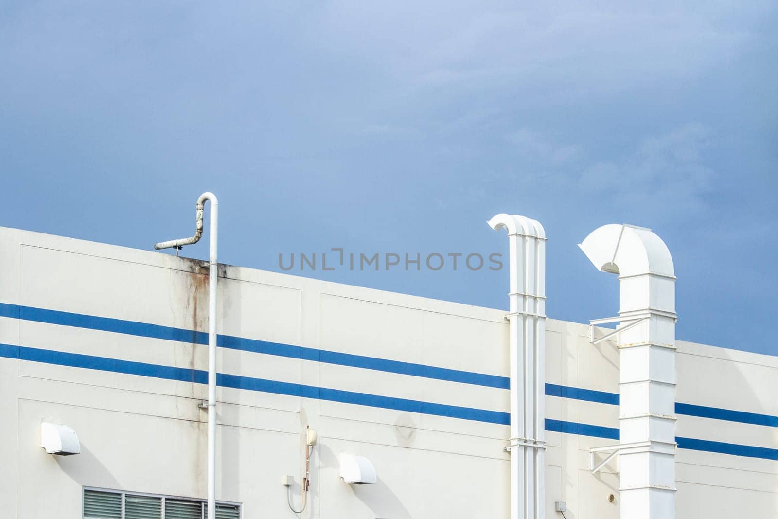 Several white ventilation vents are located next to the building.