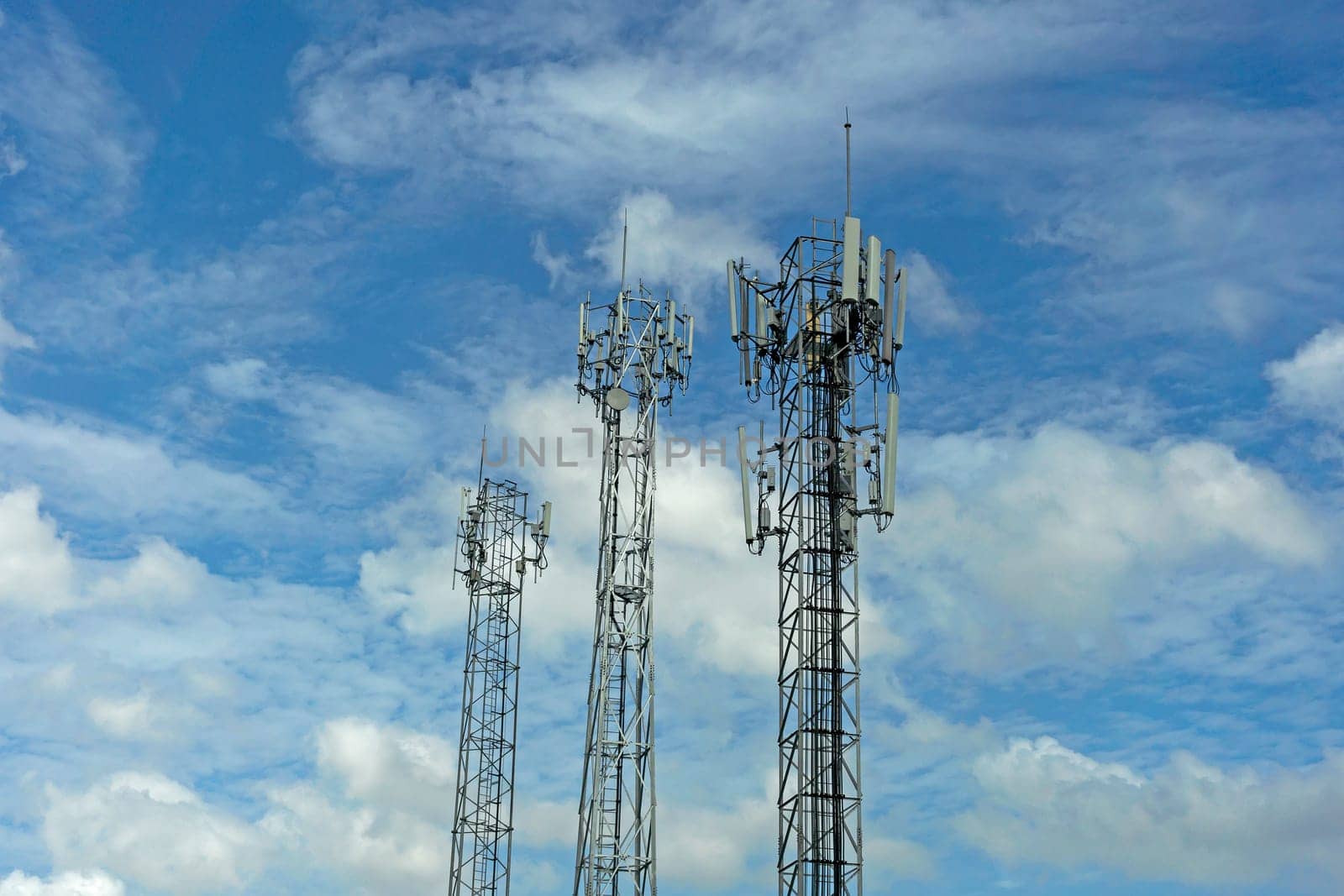 Mobile phone communication tower transmission  signal with blue sky background and antenna
