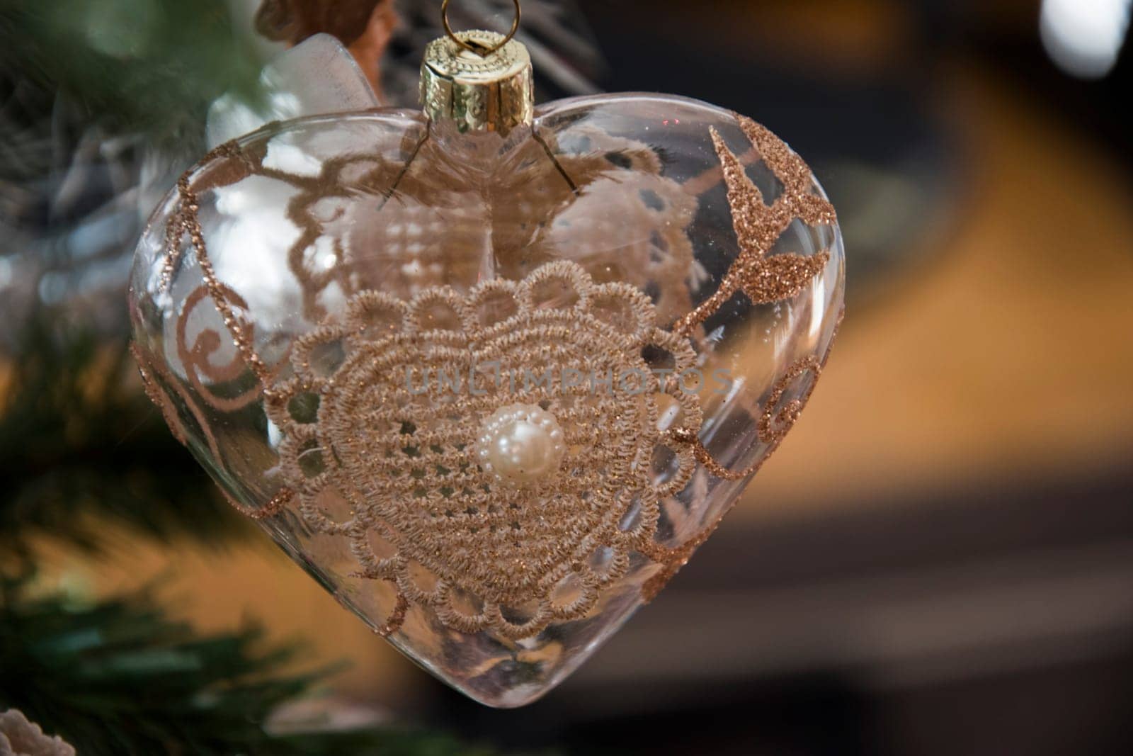 Heart ornament hanging on christmas tree. Beautiful close up holiday photo. .