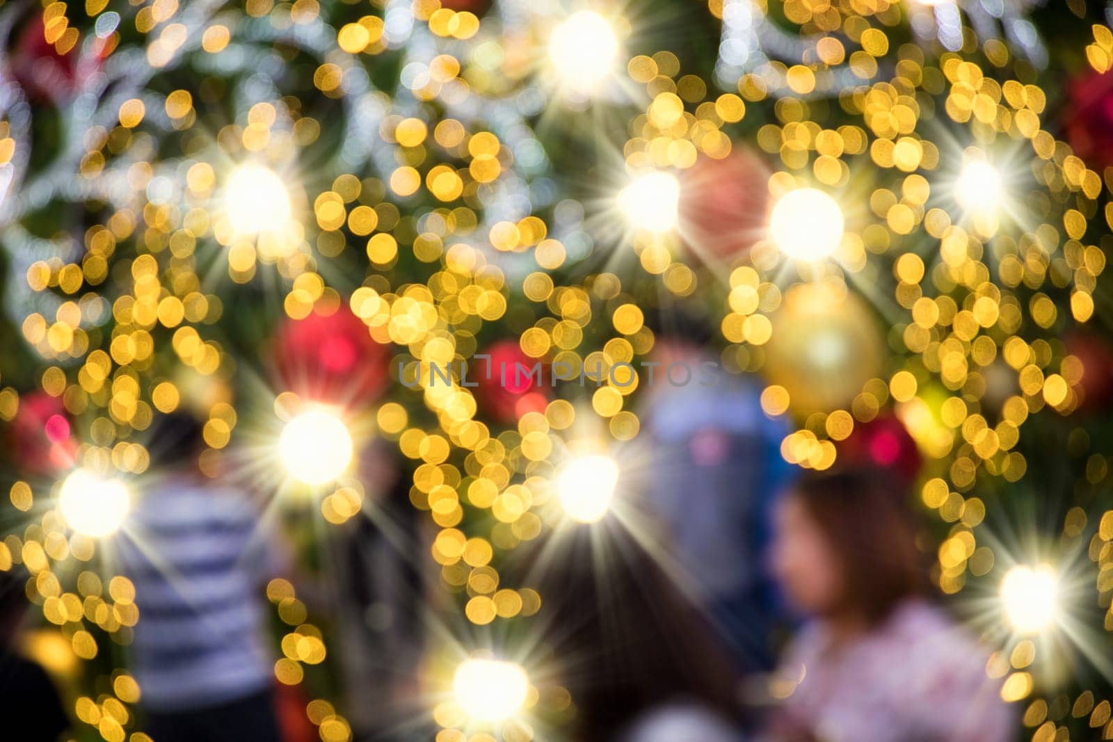 Conceptual defocused Christmas decoration on city street at night