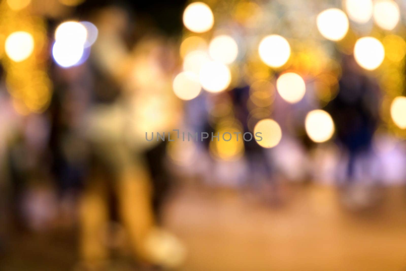 Conceptual abstract background image of defocused Christmas decoration on city street at night