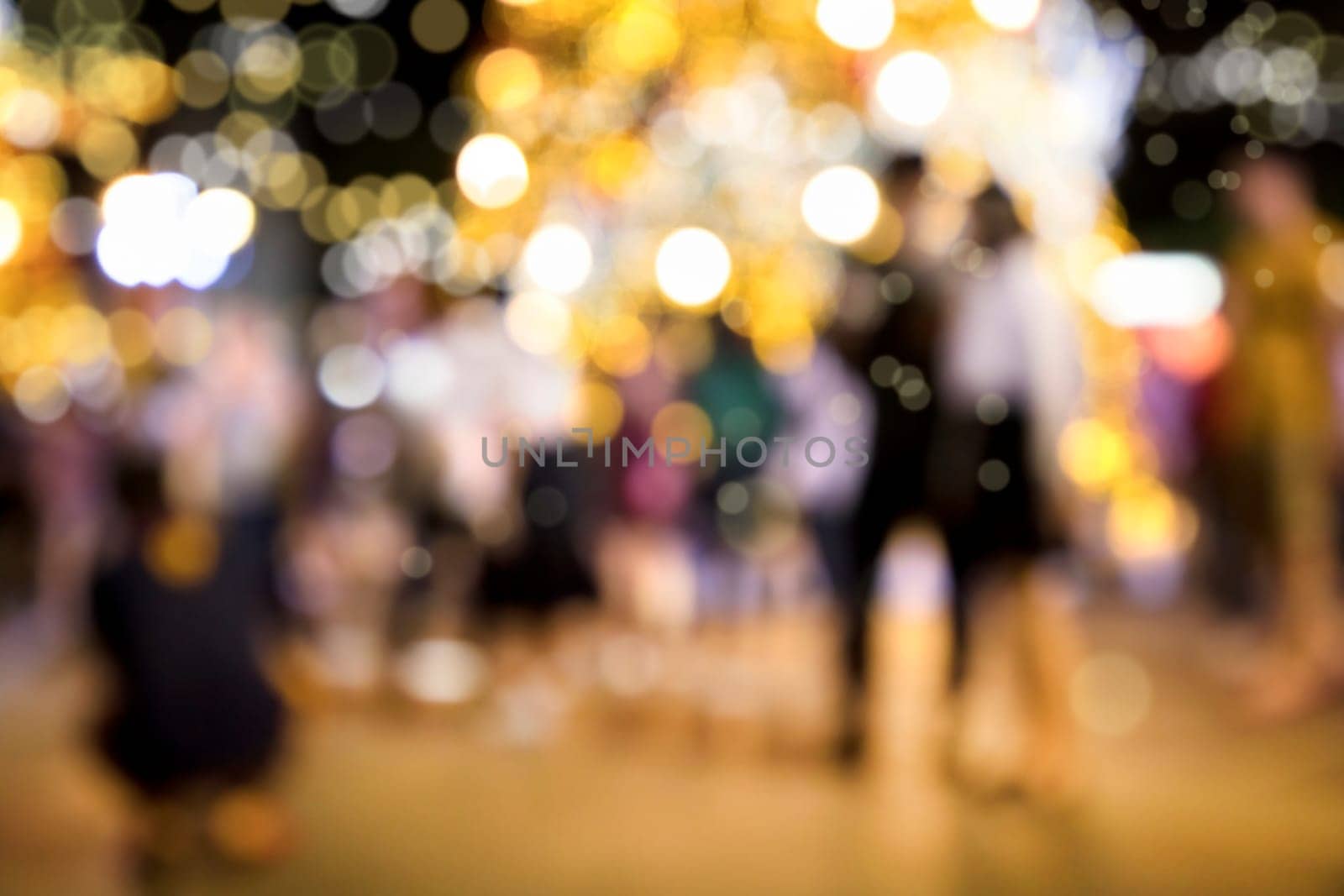 Conceptual abstract background image of defocused Christmas decoration on city street at night