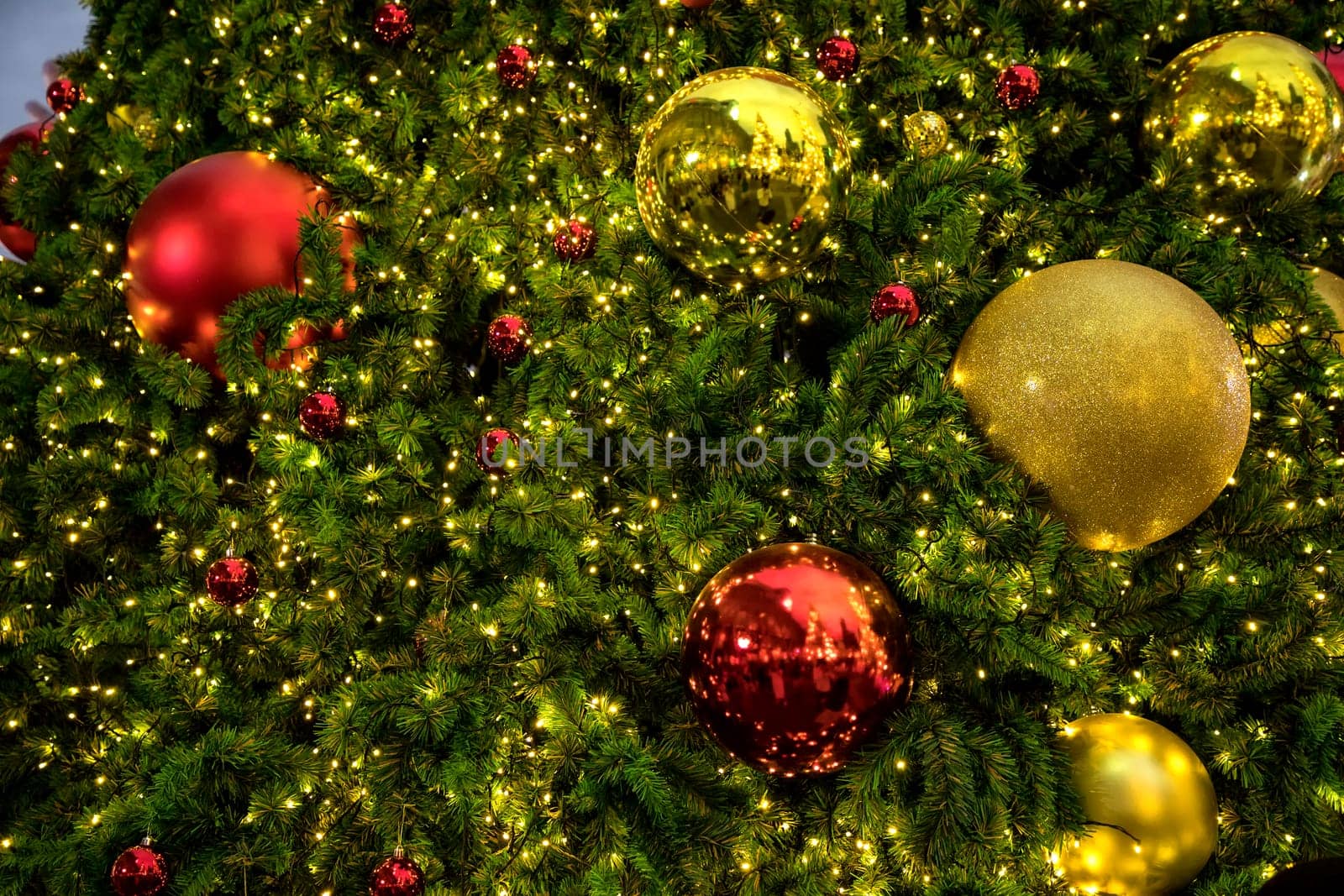 Conceptual image of decorated Christmas tree with colorful lights and ornaments
