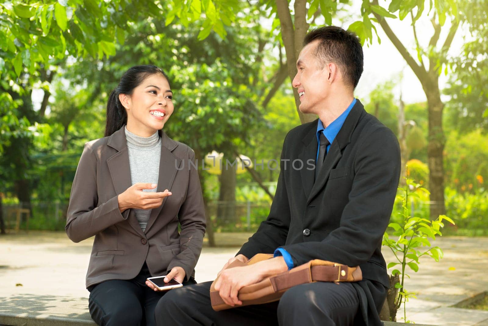 Portrait of business people relax and discuss something on the park