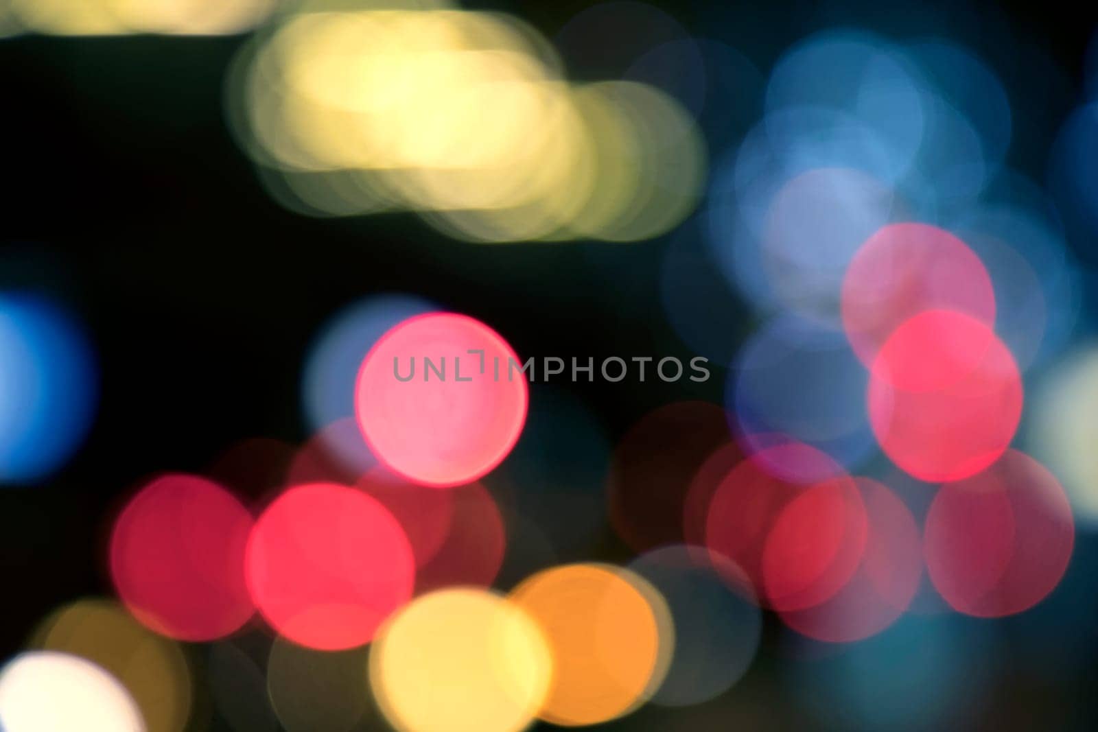 Blurry background image of defocused colorful abstract city street lights at night