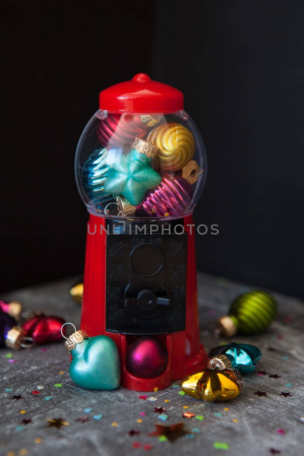Colorful christmas baubles in bright colors in a chewing gum dispenser