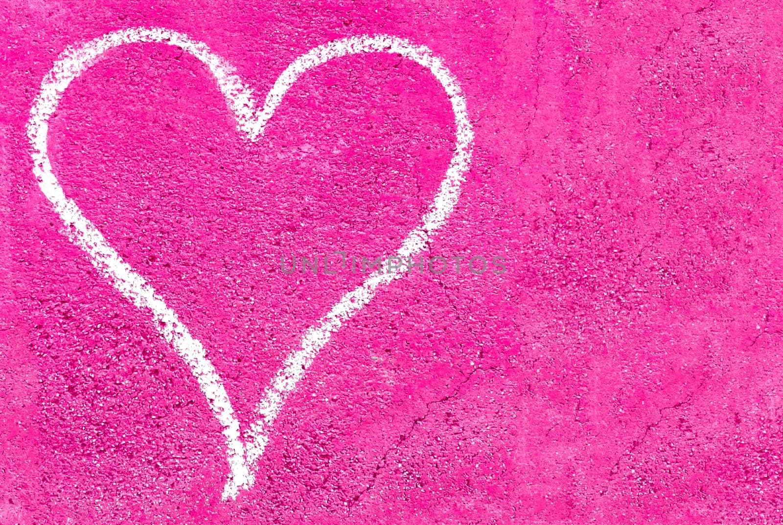 White heart on pink grungy wall. Ideal for your creative backgrounds.