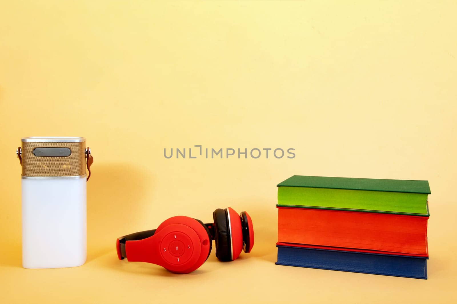 Electronic equipment smart speaker, Headphone and Books on beige Background