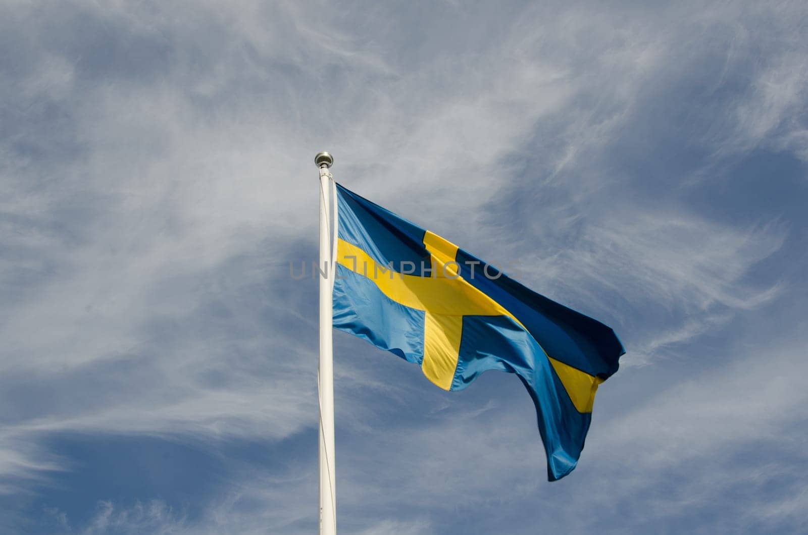 the swedish flag against a blue sky a beutiful summerday