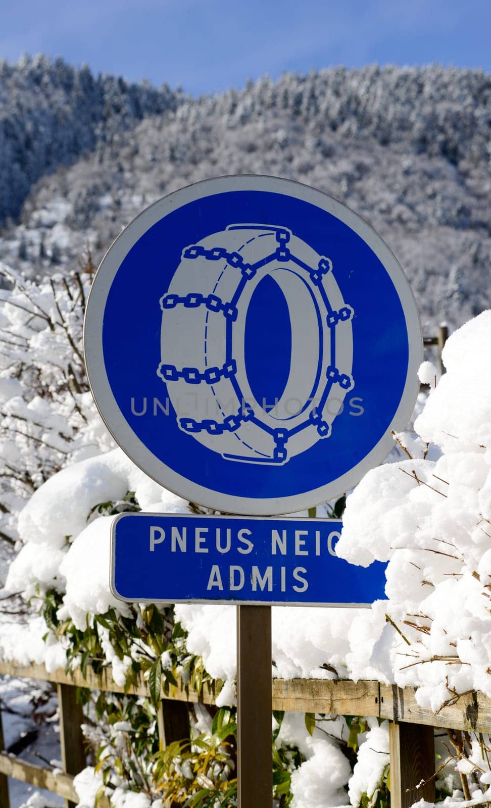 road sign on a snowy road on mountain
