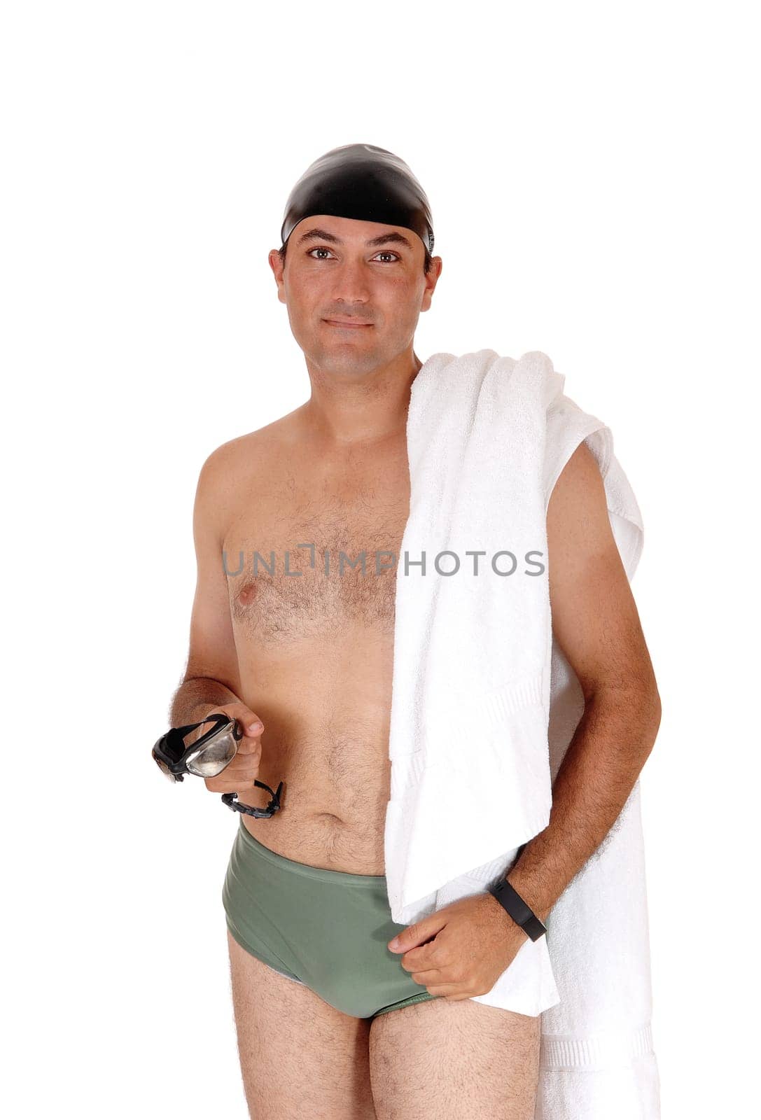A tall handsome man in a green swimsuit standing from the front.with his towel and swim google and cap isolated on white background.