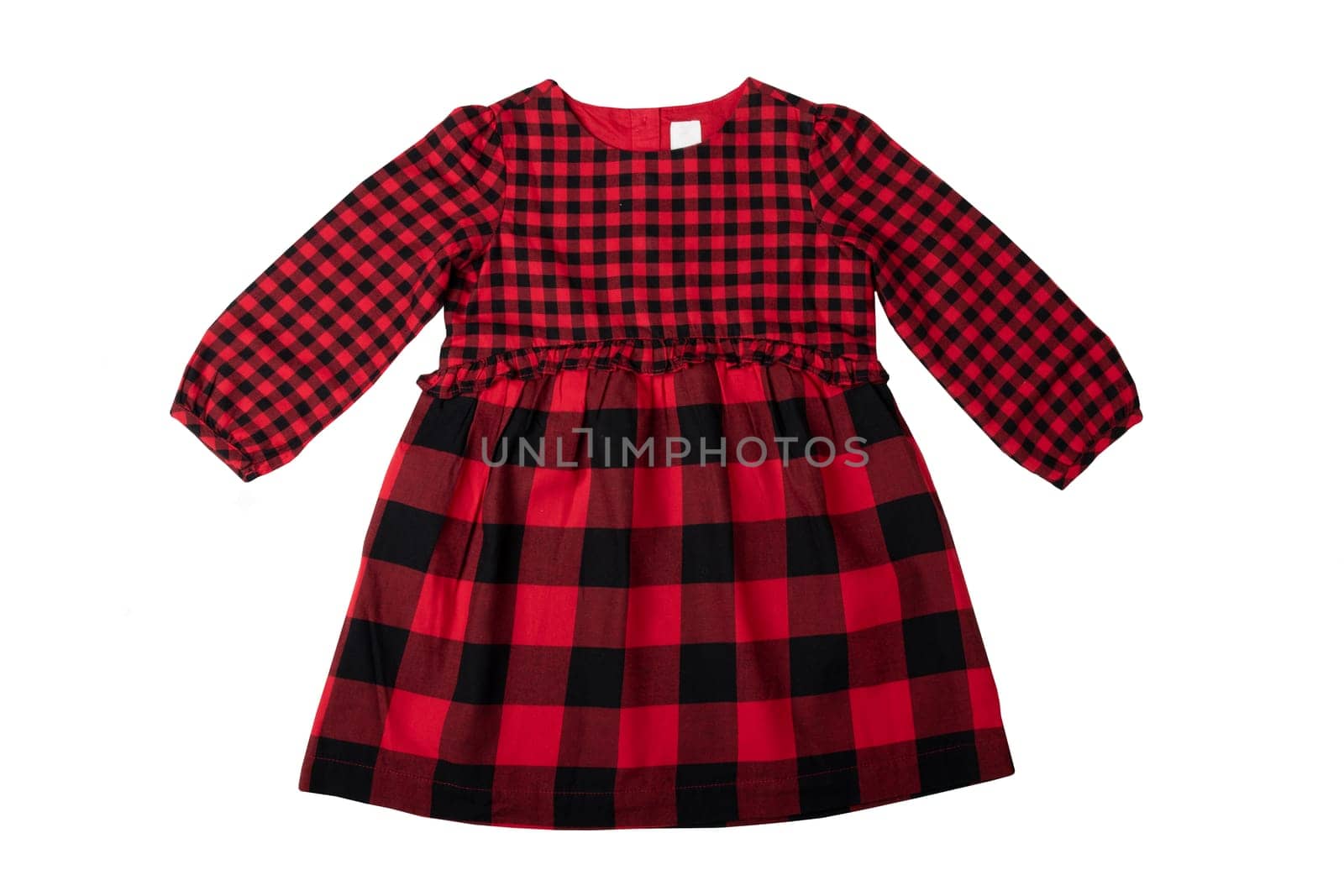 Clothes for children. A beautiful red and black checkered girl dress isolated on a white background. Children fashion.