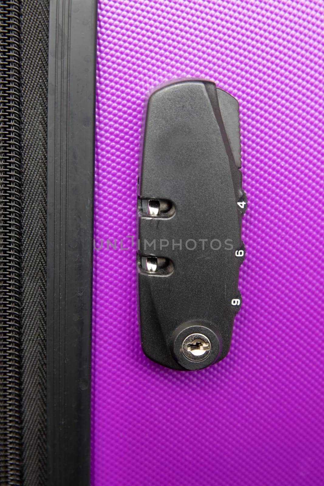 Top view on suitcase combination lock on purple suitcase. Concept travel safety and insurance.
