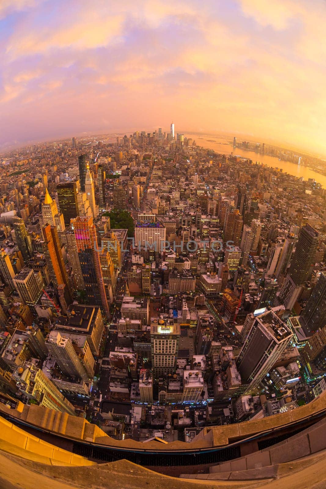 New York City skyline with Manhattan skyscrapers at dramatic vibrant after the storm sunset, USA. Rainbow and lightnings can be seen in background over Brooklyn bridge.