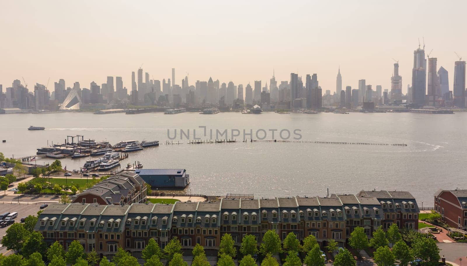 New York City midtown Manhattan sunset skyline panorama view from Boulevard East Old Glory Park over Hudson River.