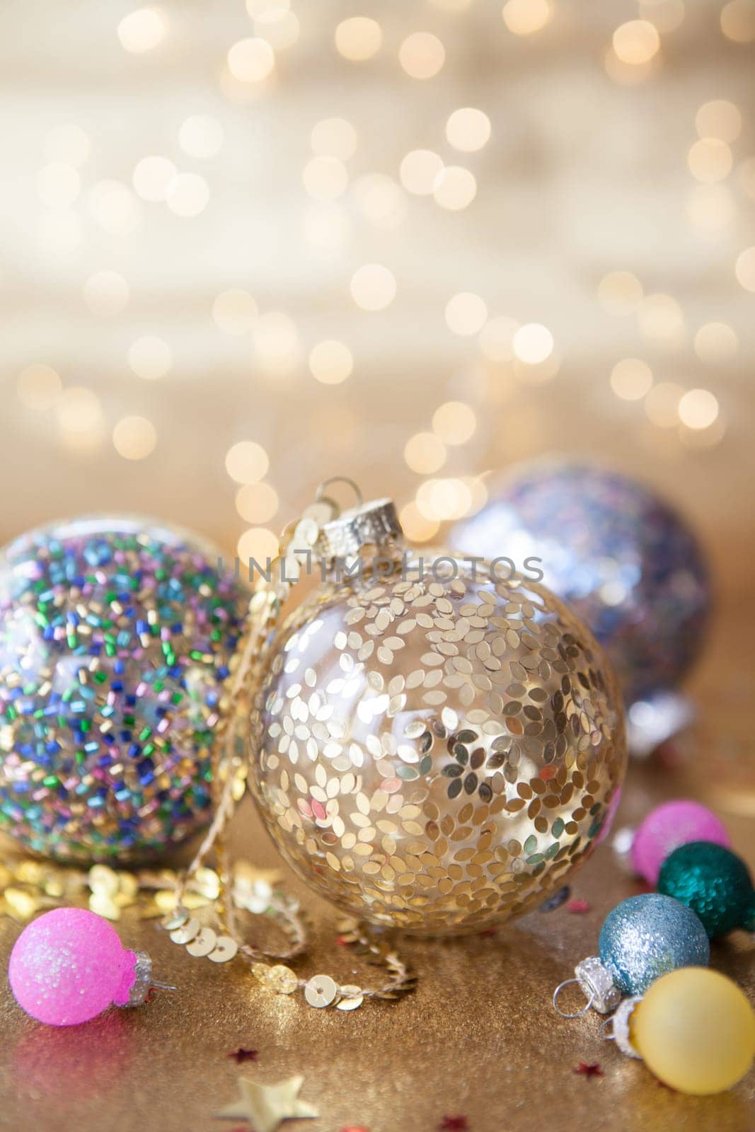 Glittery christmas decorations in front of festive lights