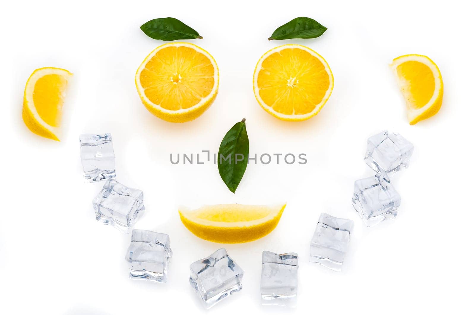 Bright lemon slices, green leaves and ice cubes in the shape of a face. healthy lifestyle.