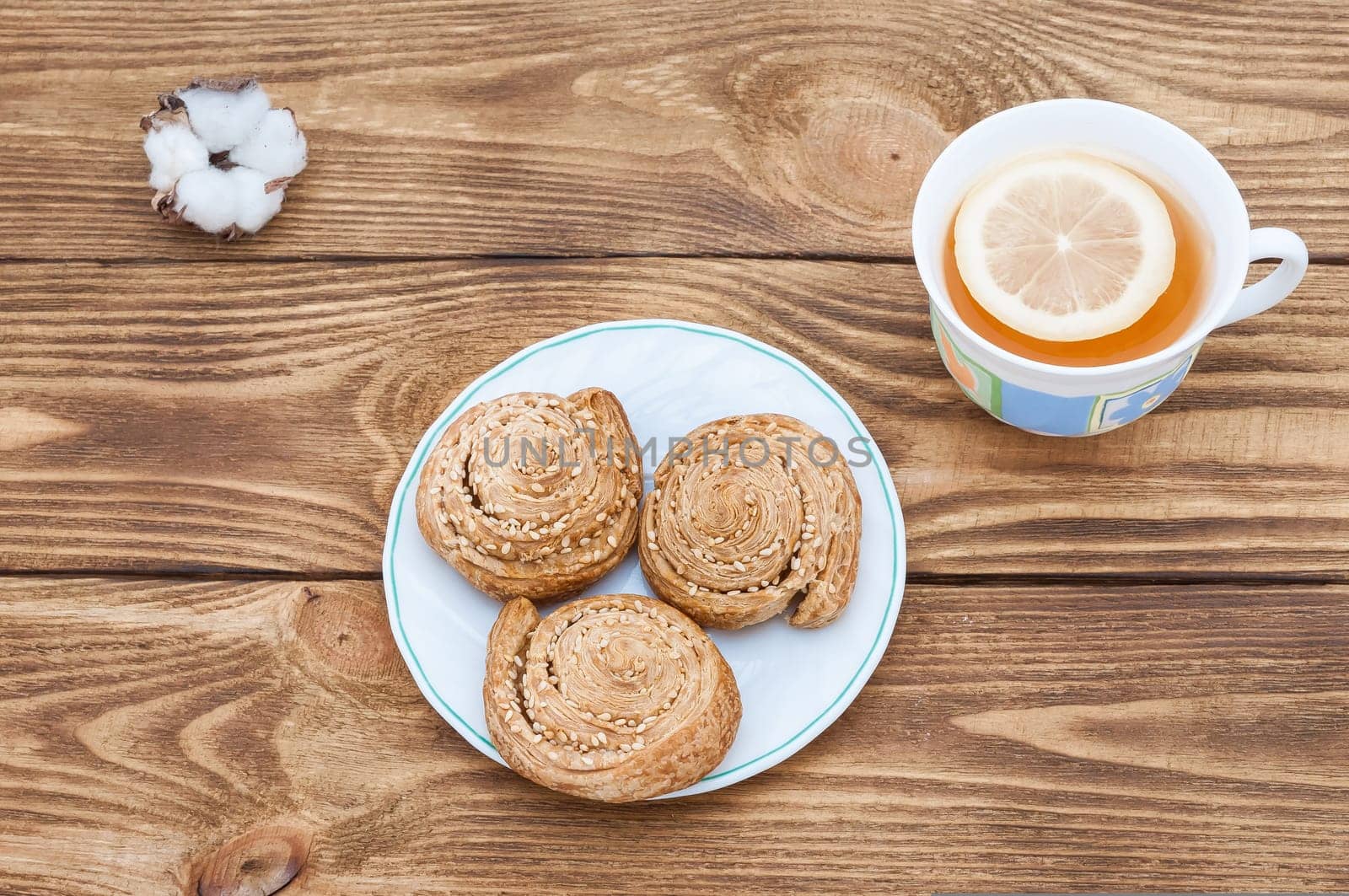 Plate with homemade cookies with sesame and tea with lemon.
