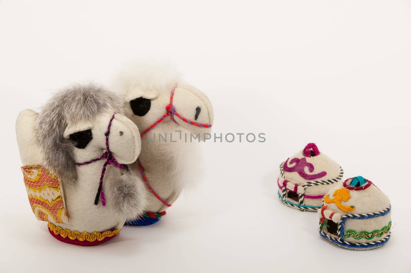 Toy two camel and two eastern houses isolated on the white background.