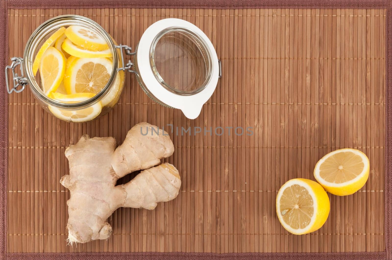 Ginger and lemon in a jar on a bamboo mat