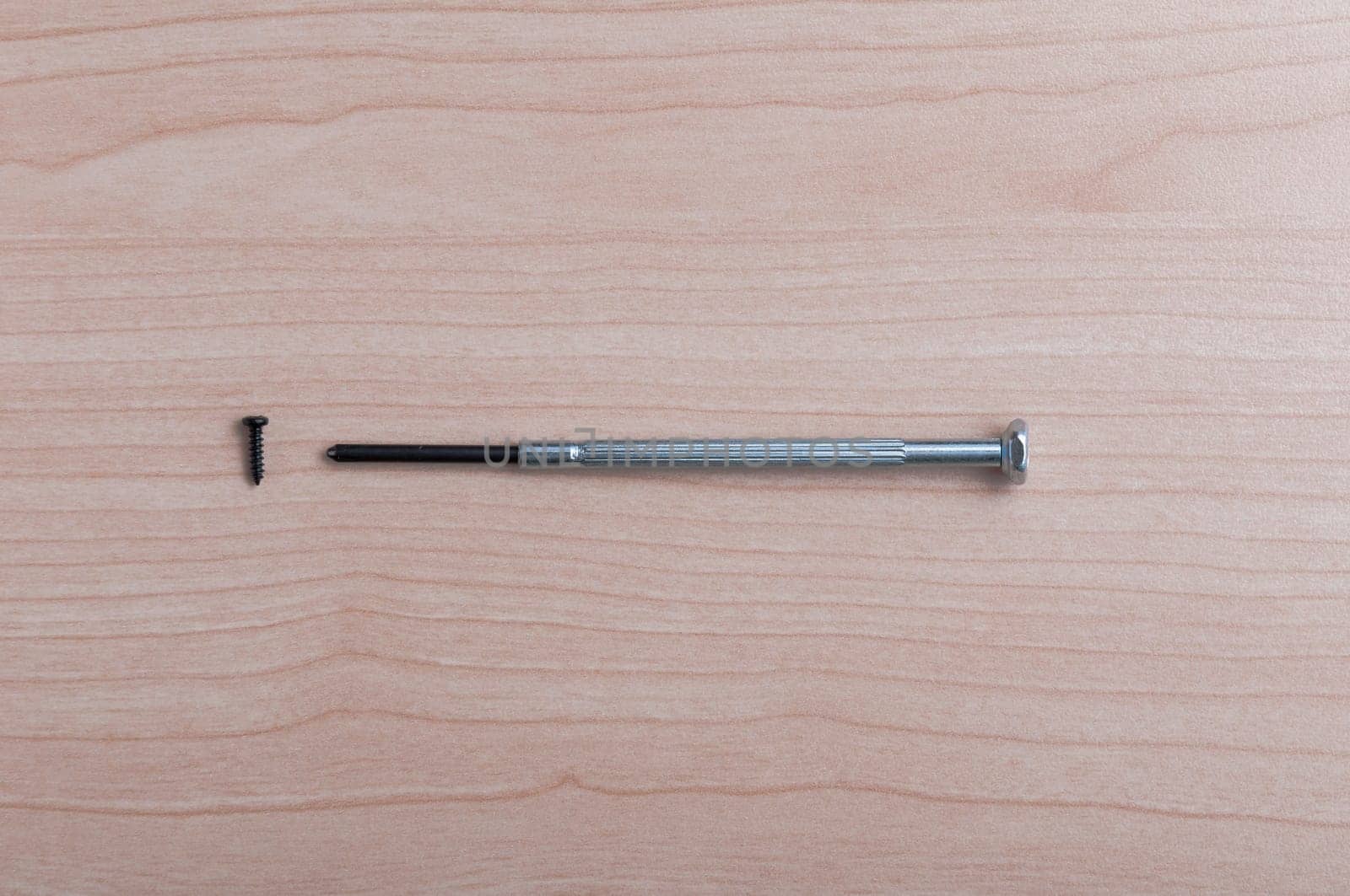 An improvement and a little screwdriver screw on wooden table