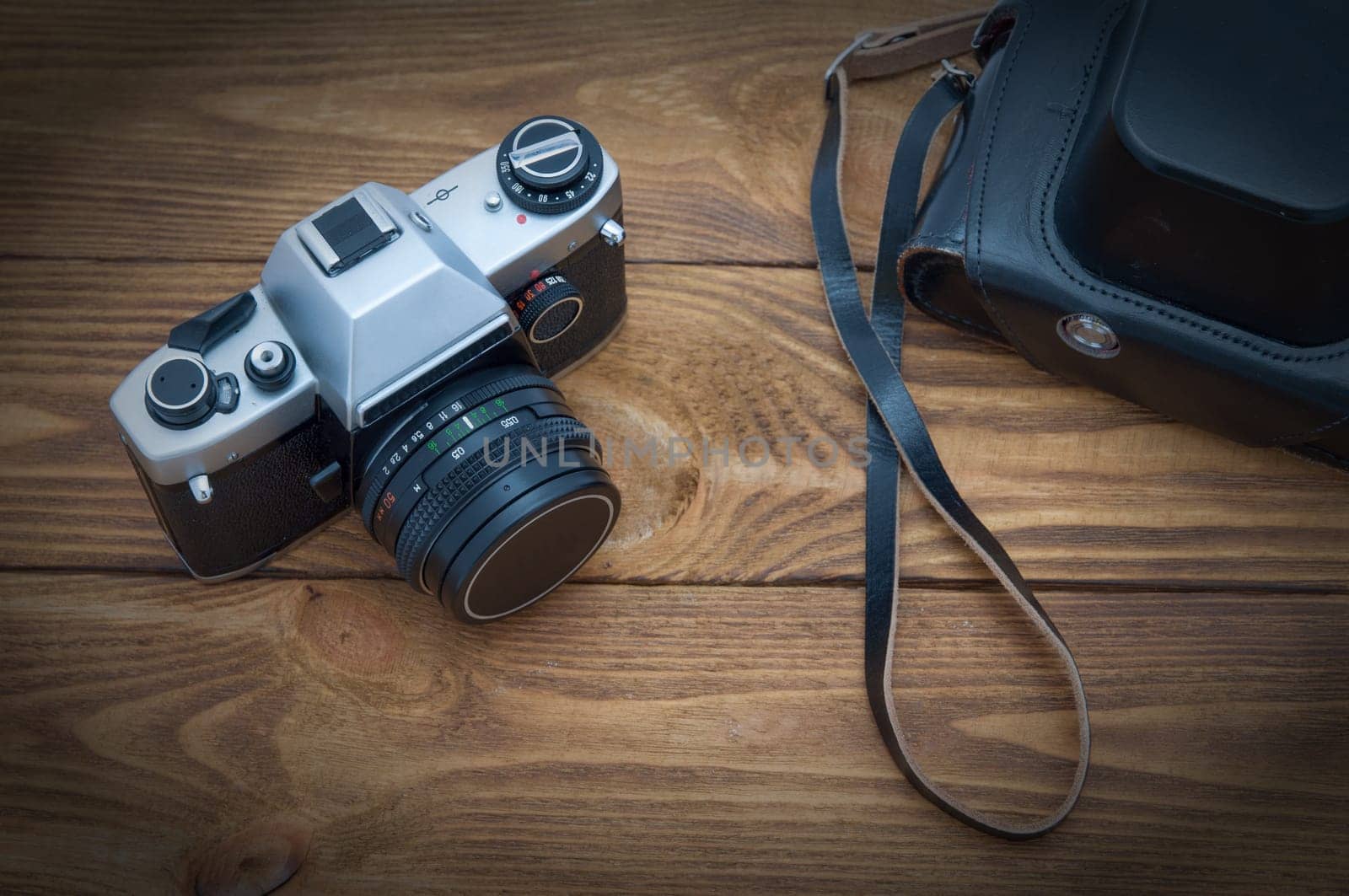 Old film camera on a wooden table.in the studio.