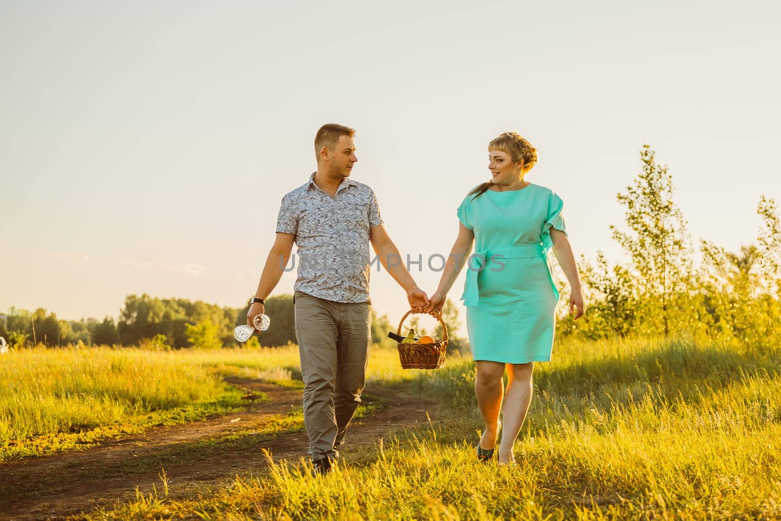 Romantic couple standing and kissing on background summer lake sunset
