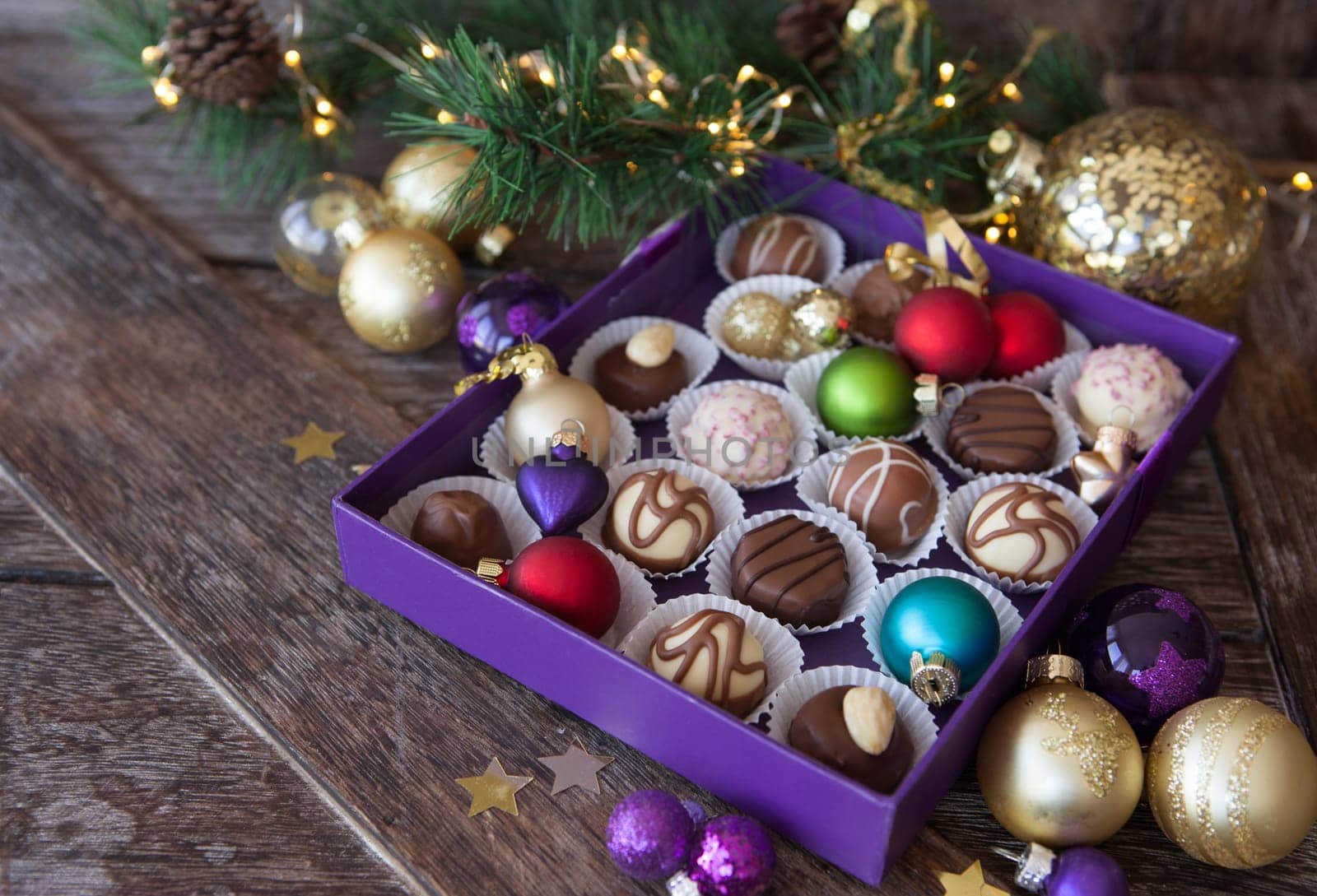 Box of chocolates with colorful baubles for a Merry Christmas