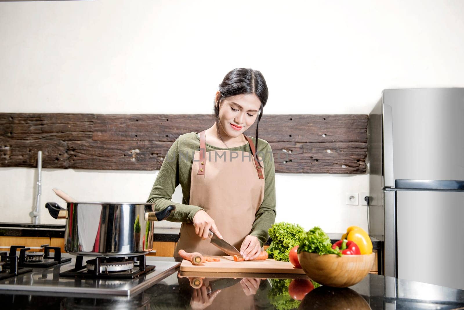 Pretty asian woman is preparing food in the kitchen