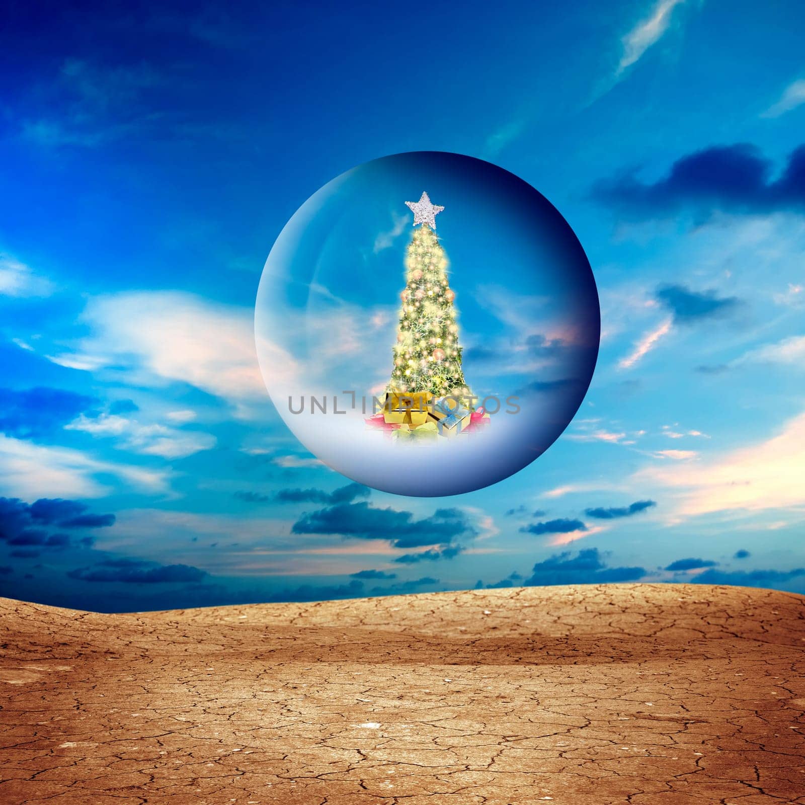 Decorated Christmas tree in glass sphere floating in air over dried and cracked landscape
