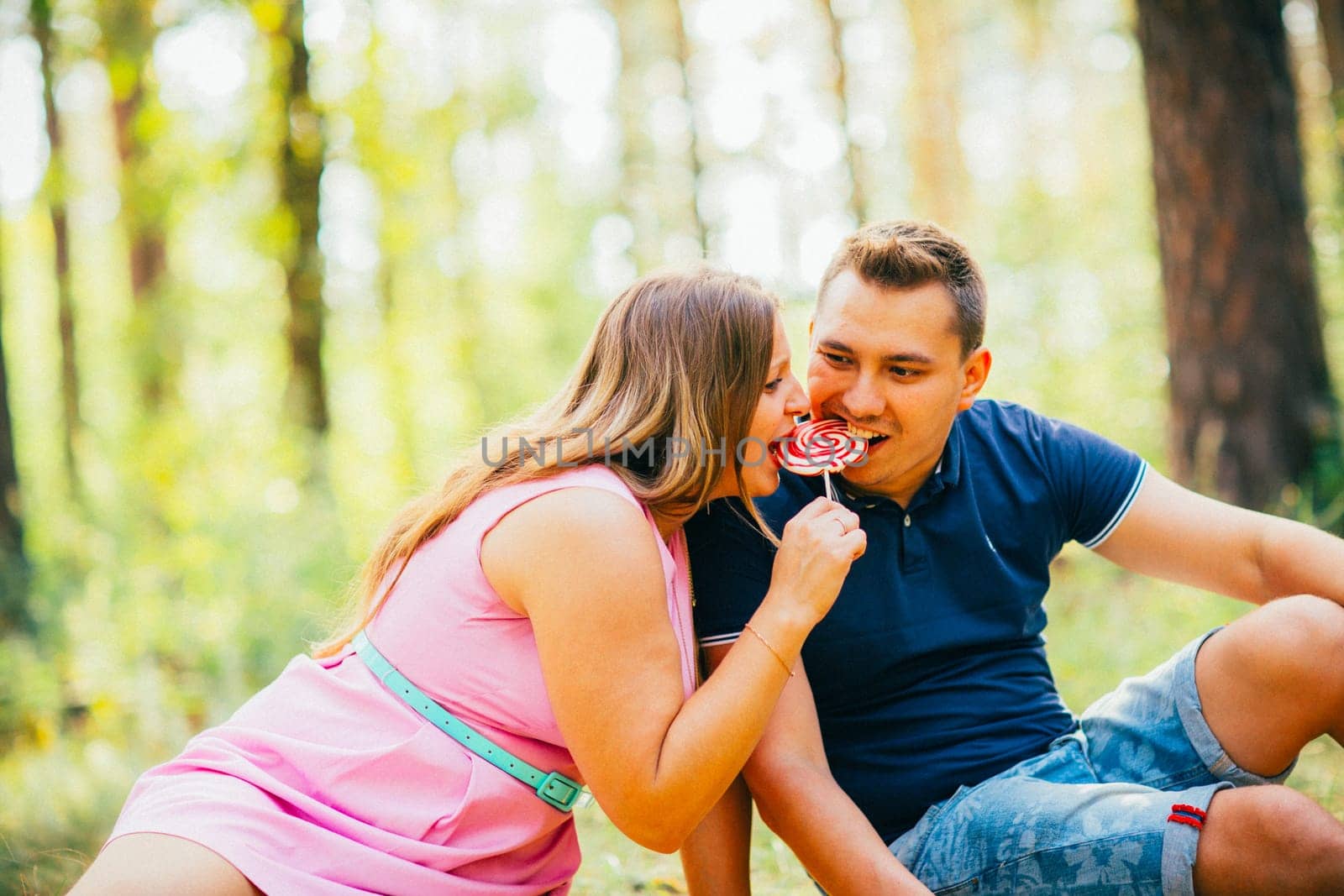 Romantic young couple kissing on background summer forest
