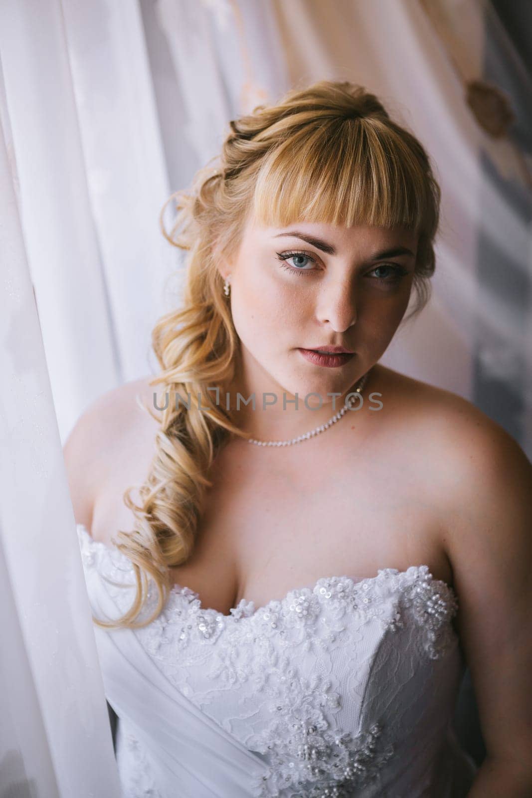 beautiful young bride stand on background forest