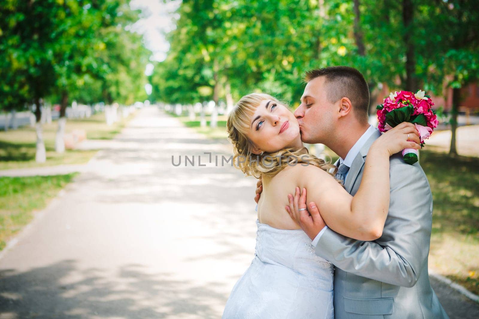 beautiful young couple stand on background forest