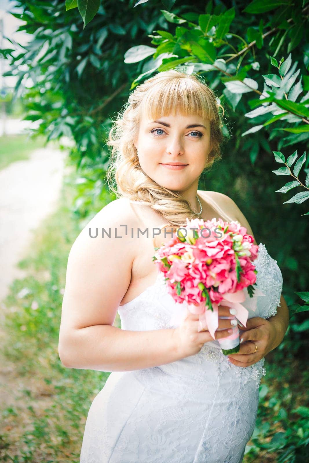 beautiful young bride stand on background forest