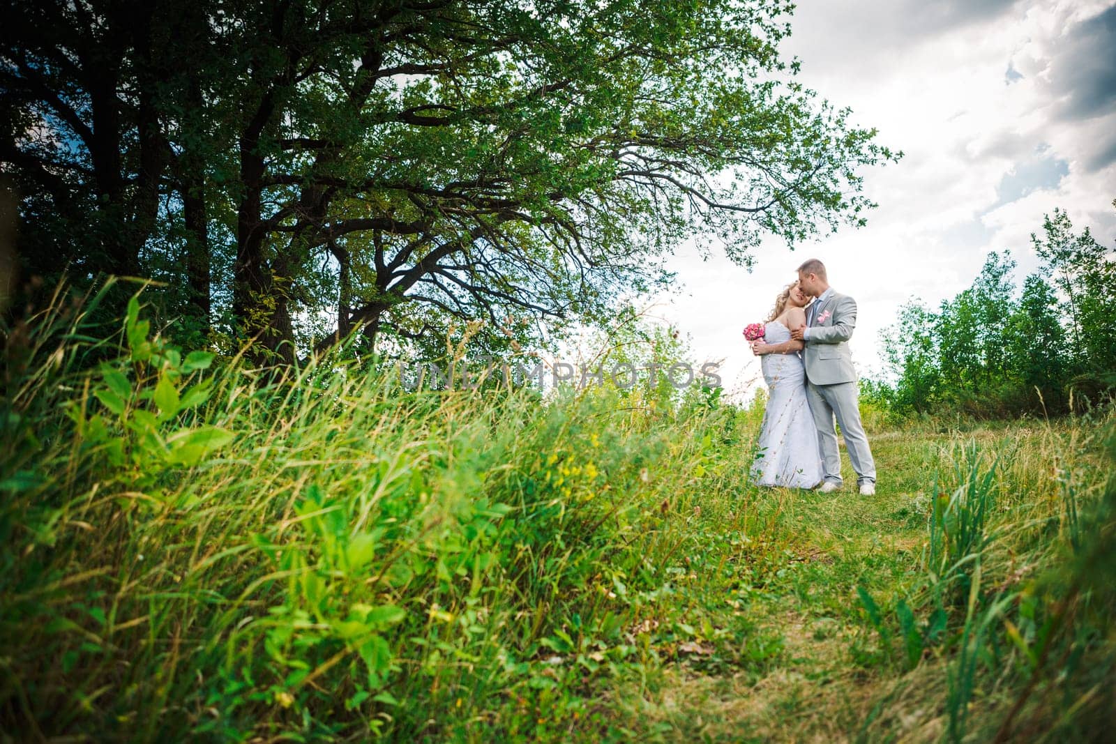 beautiful young couple stand on background forest