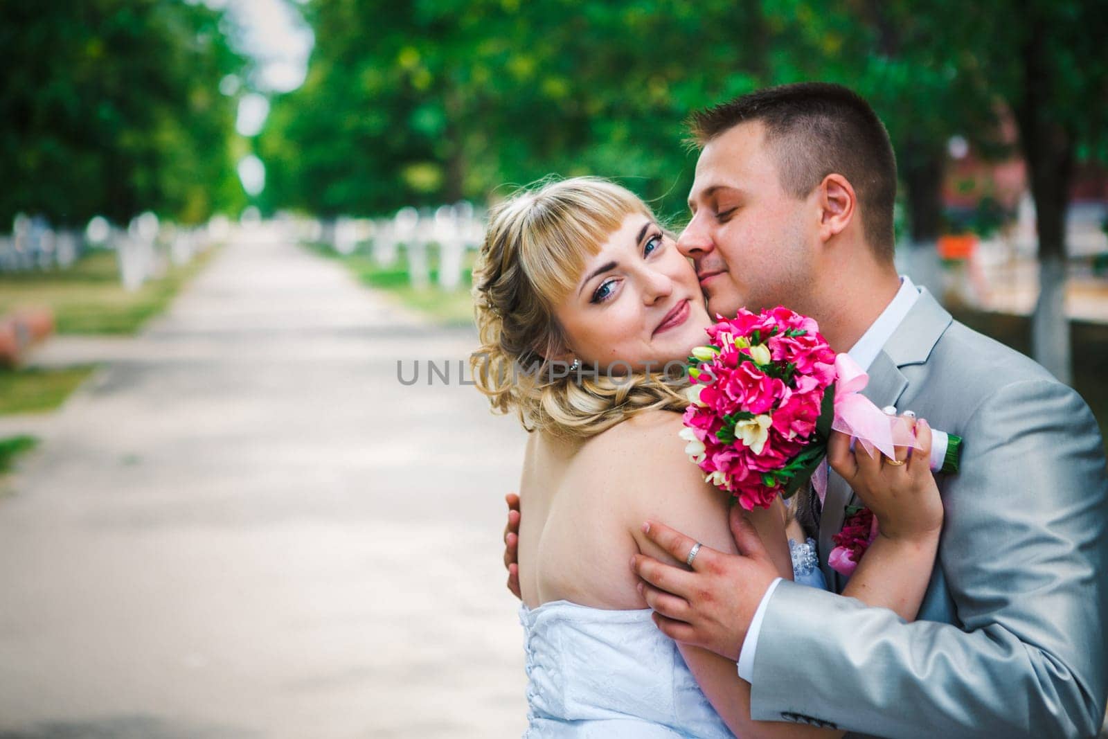 beautiful young couple stand on background forest