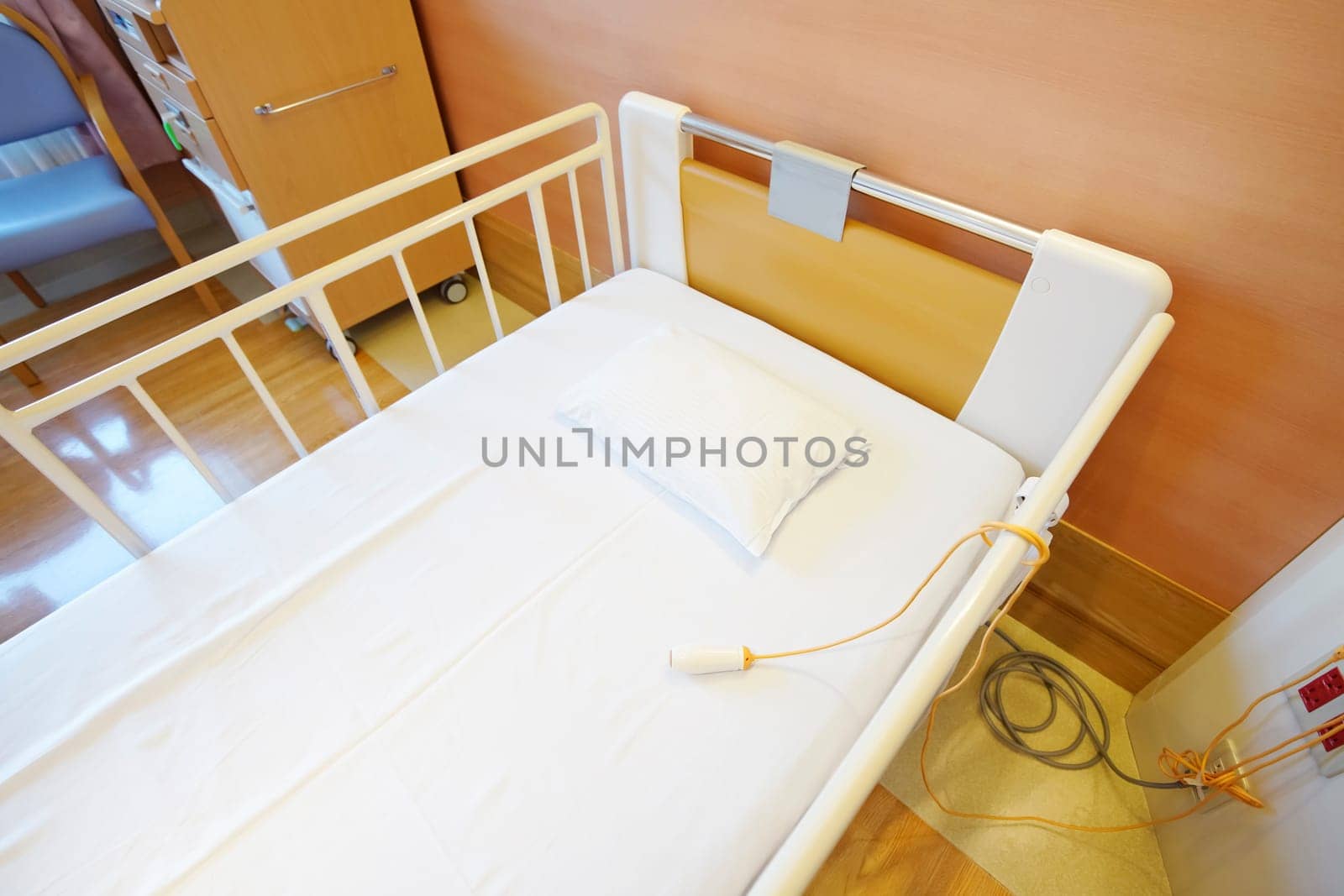 Room with empty bed and medical equipment in a hospital