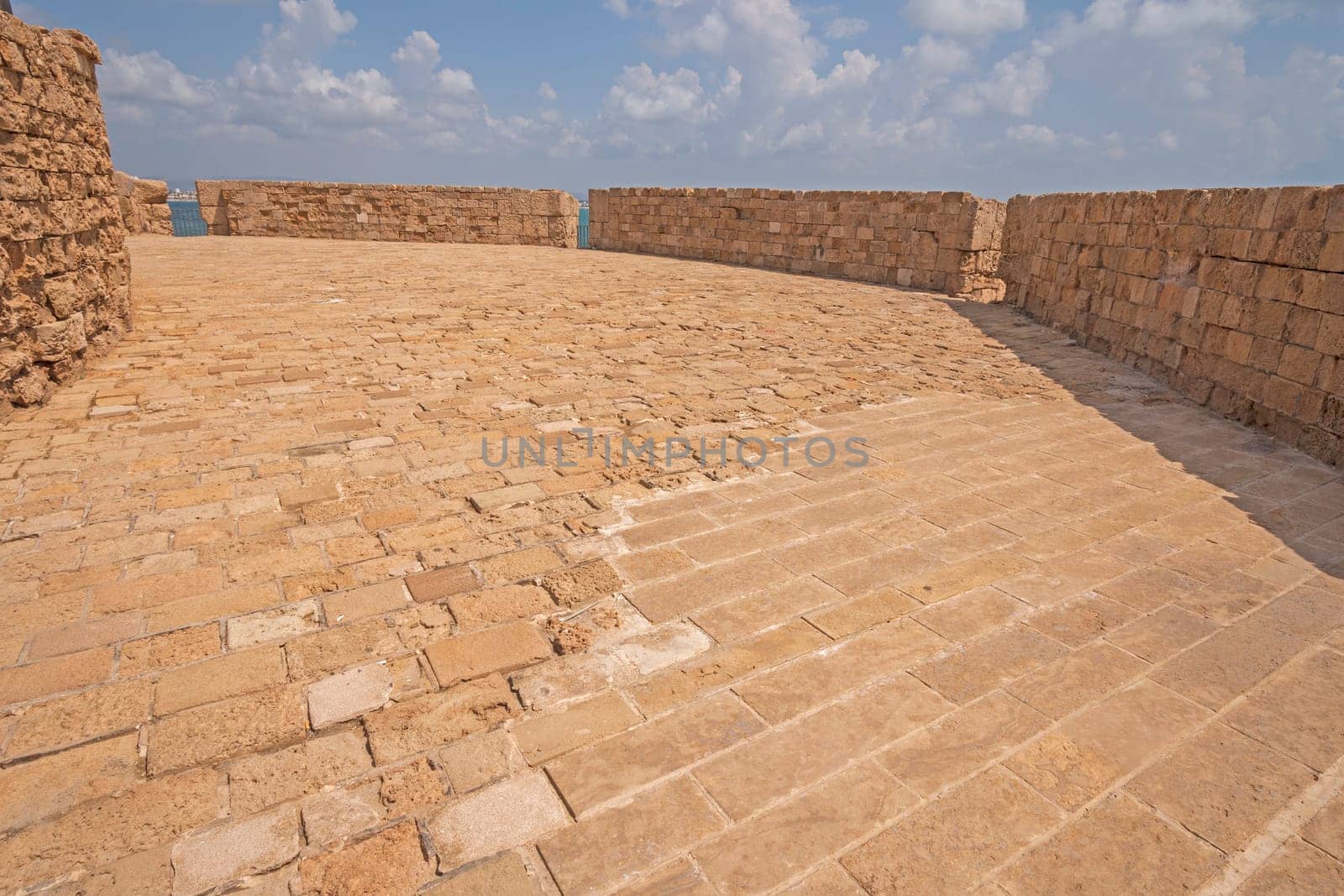 Old brick walkway on a Fotress Wall on the coastal fortress in Acre, Israel