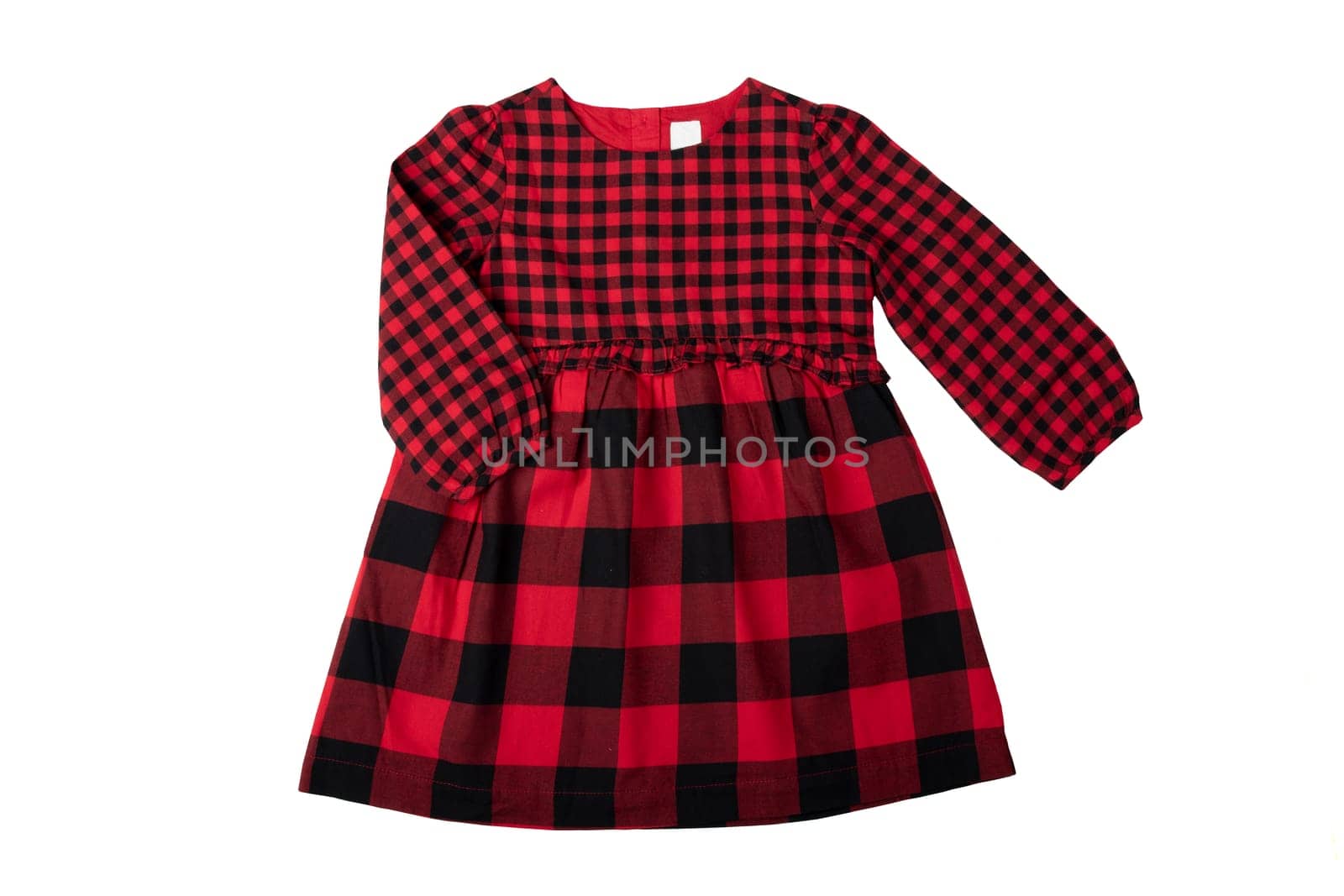 Clothes for children. A beautiful red and black checkered girl dress isolated on a white background. Children fashion.