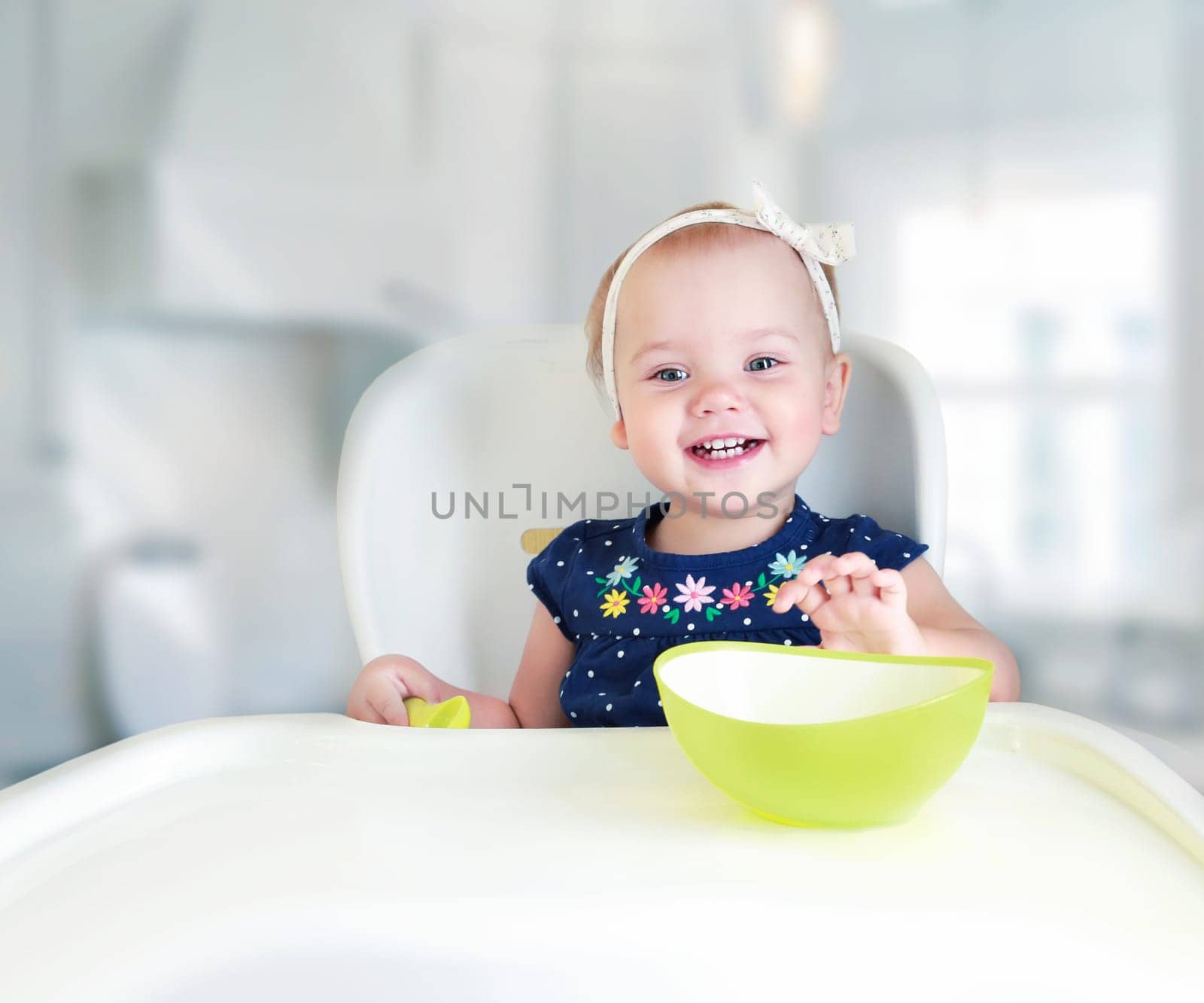 Child sitting at table empty space.Kid's nutrition advertisement design.Baby eating.